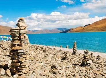 You will see the Mani stones at the lake side or the foot of the mountain in Tibet. The sky is very blue in Winter.